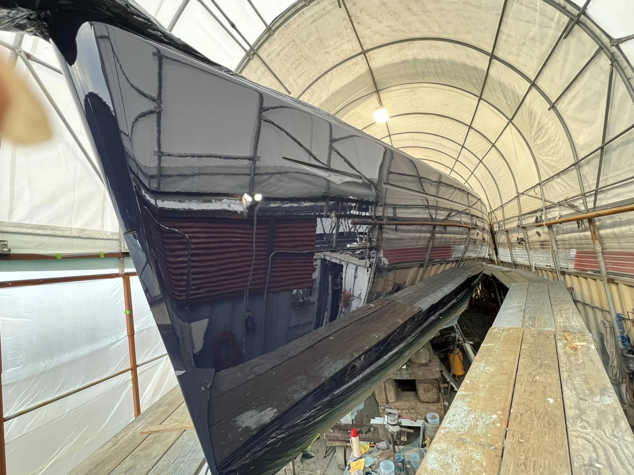 Fresh hull paint with mirror-like finish in covered bay