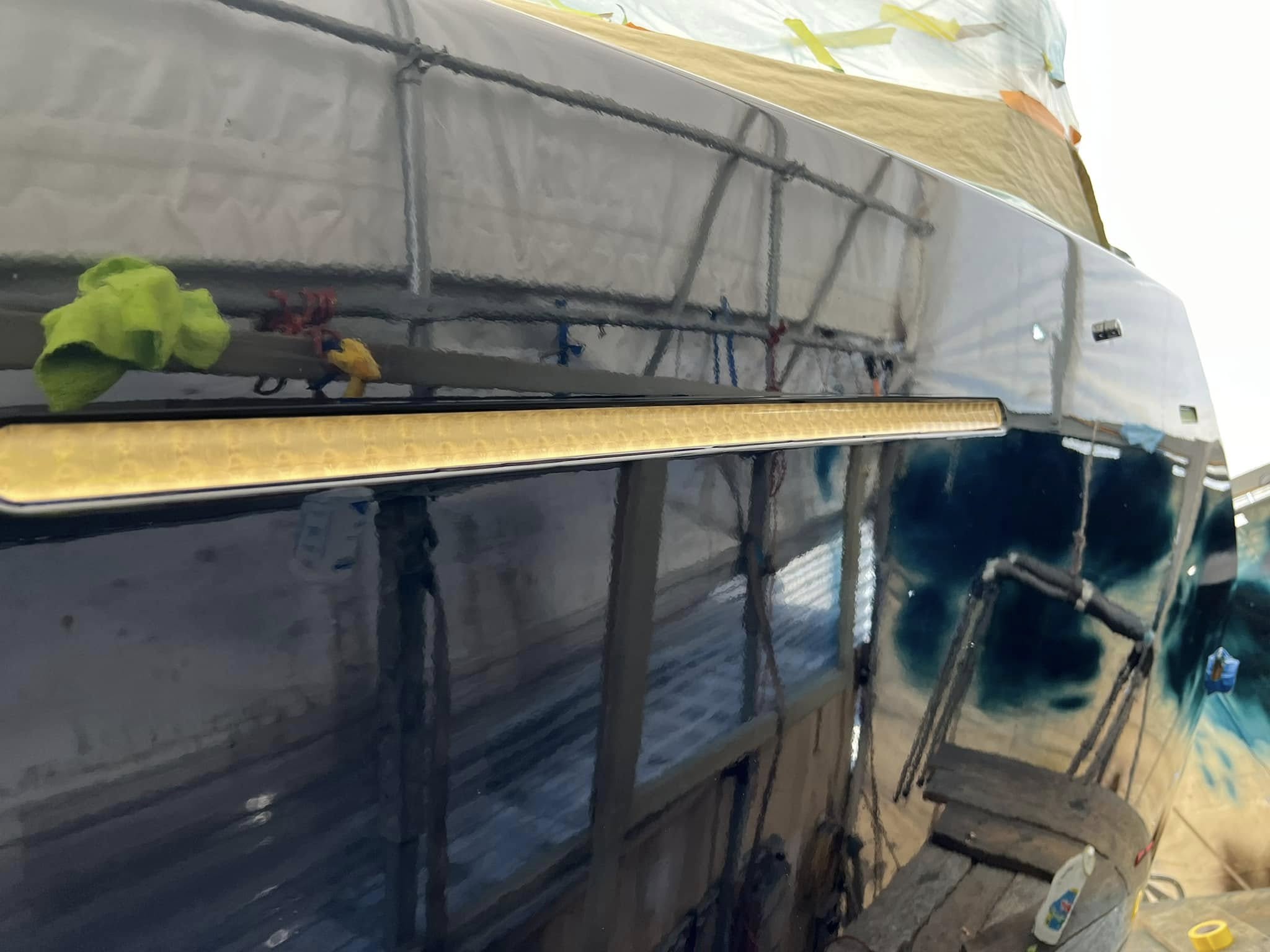 Close-up of polished hull with gold cove stripe
