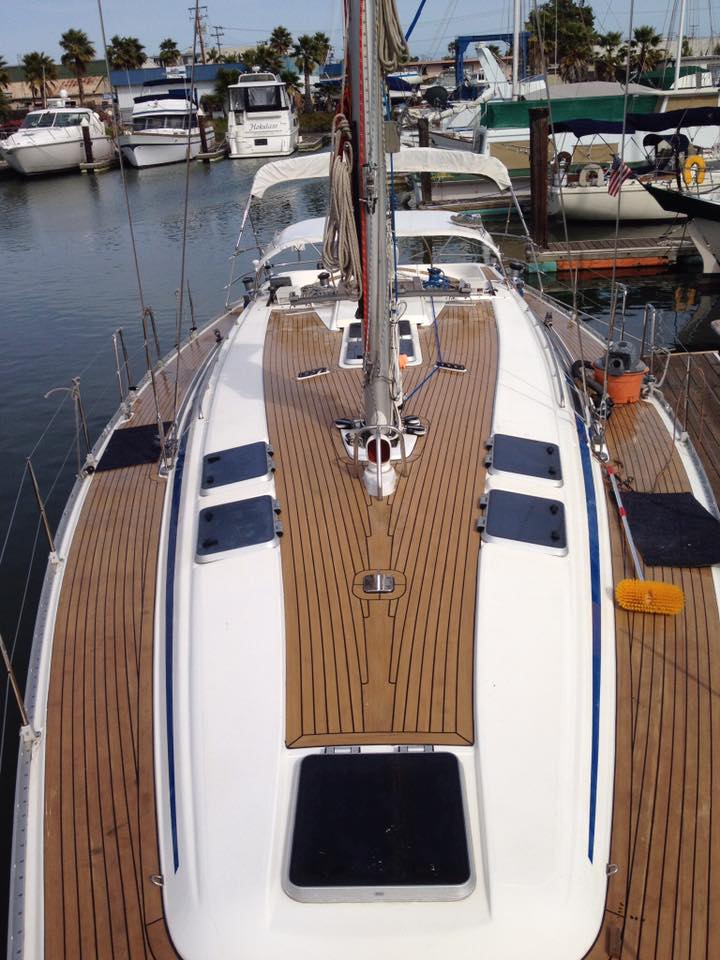 Restored teak deck sailboat docked in marina